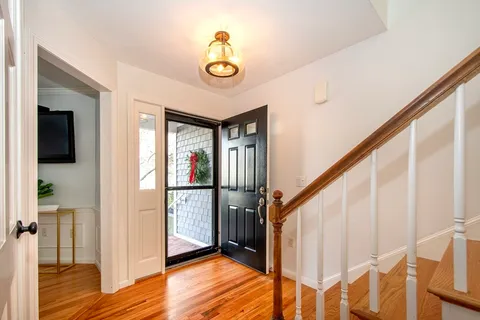 a view of entryway with wooden floor and stairs