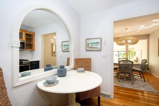 a view of a dining room with furniture and wooden floor