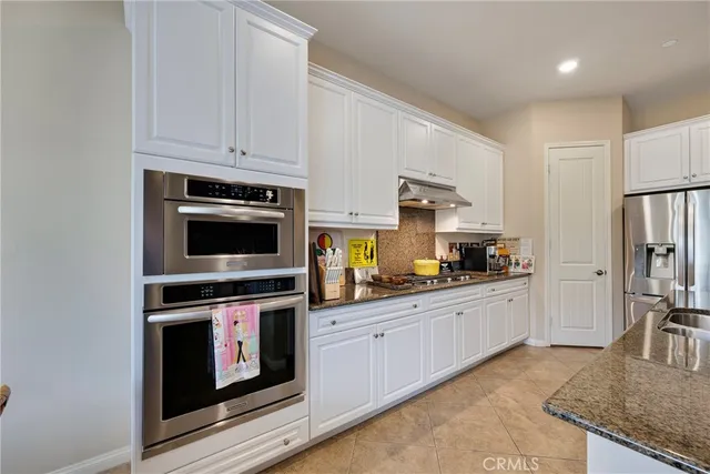 a kitchen with appliances a sink and cabinets
