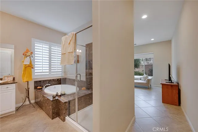 a bathroom with a granite countertop sink and a bathtub