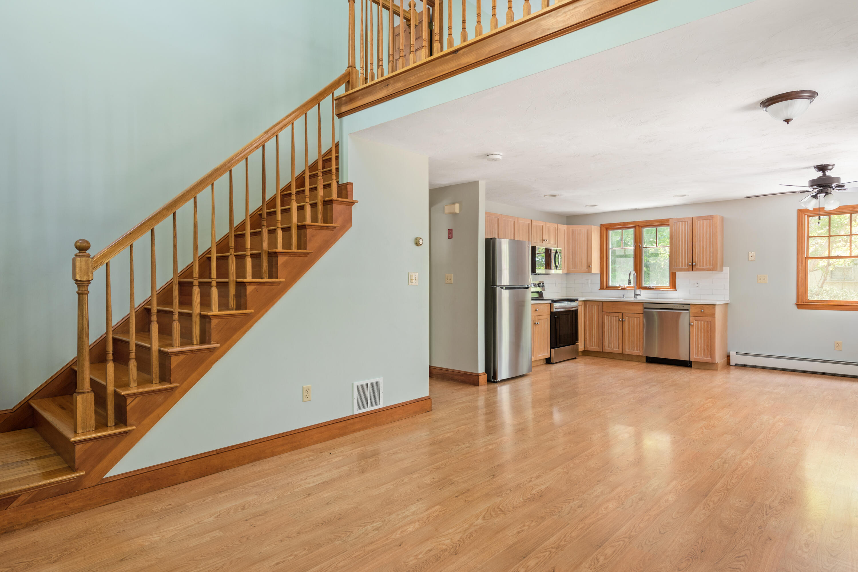 305 Monomoscoy Road Mashpee, MA 02649 - Photo 11 of 49 a view of empty room with wooden floor and stairs
