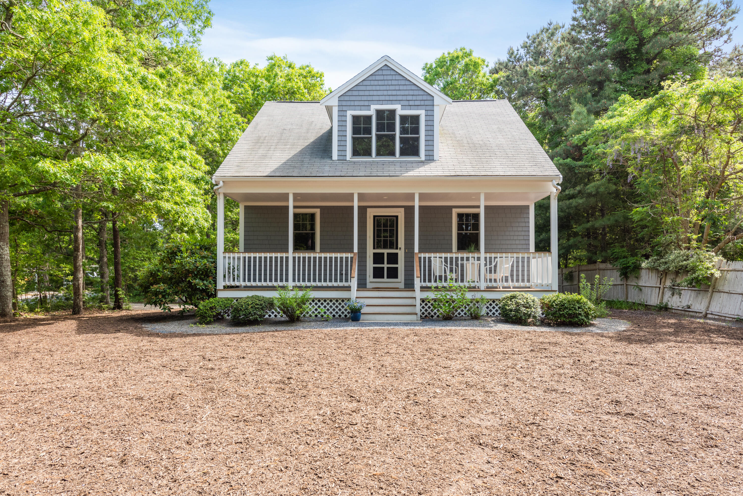 305 Monomoscoy Road Mashpee, MA 02649 - Photo 2 of 49 a front view of a house with a yard and potted plants
