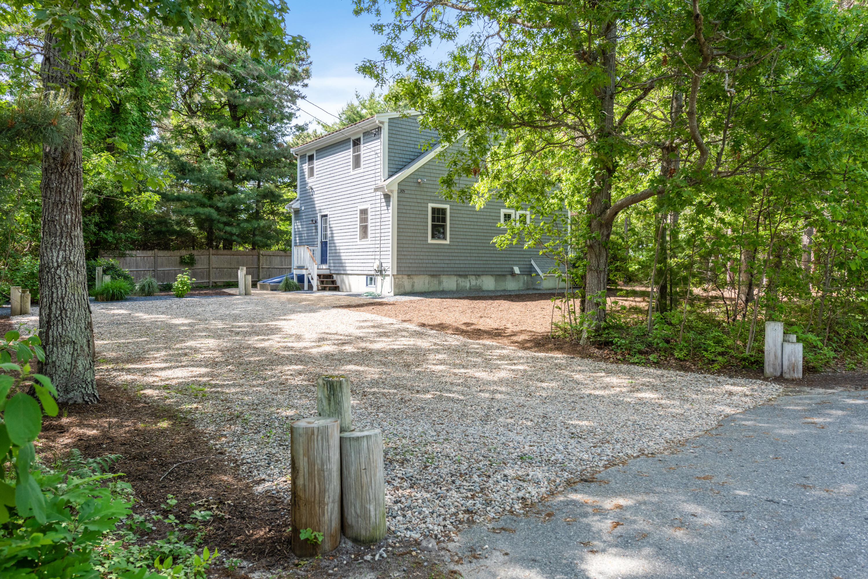 305 Monomoscoy Road Mashpee, MA 02649 - Photo 30 of 49 a view of a house with a yard