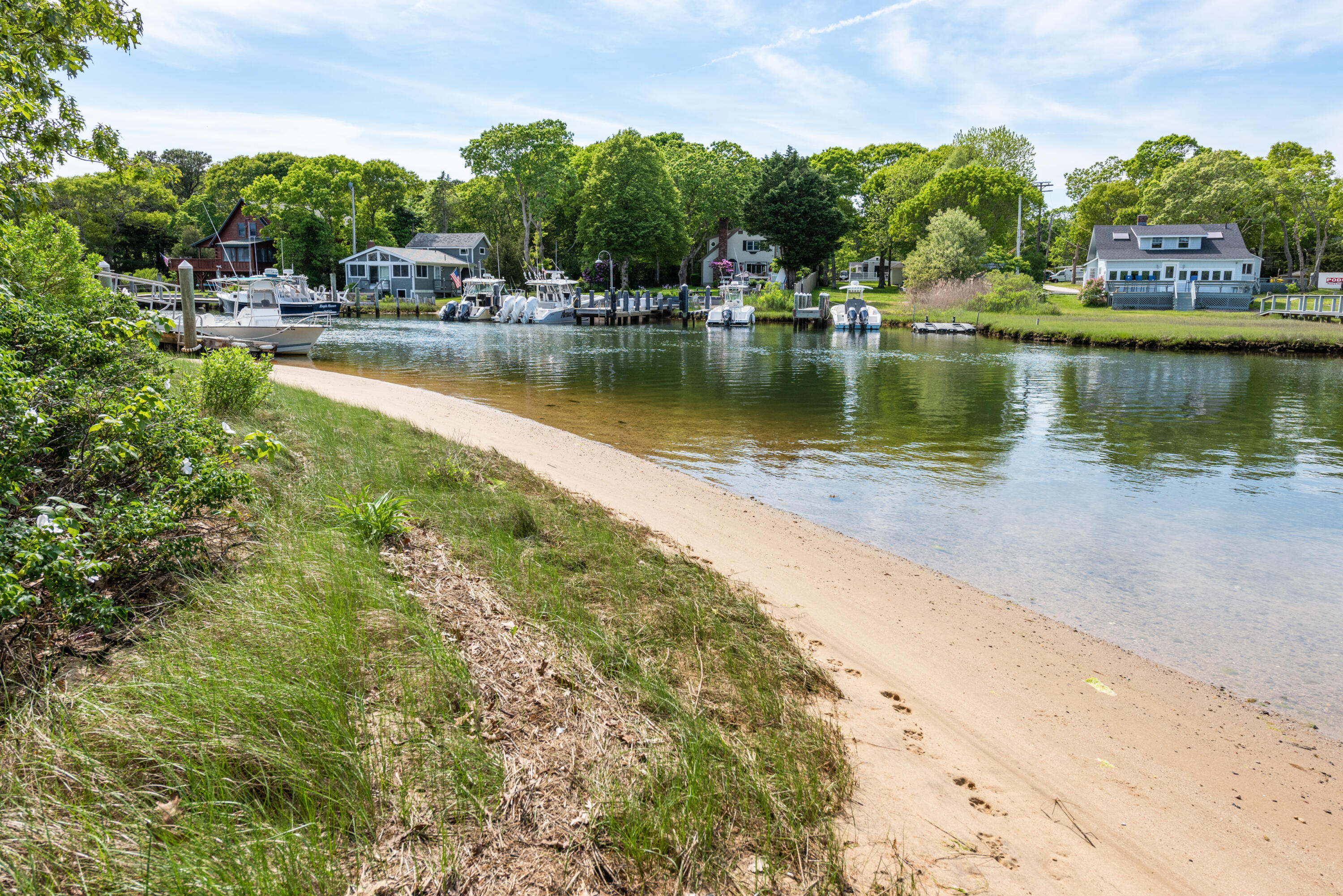 305 Monomoscoy Road Mashpee, MA 02649 - Photo 36 of 49 a view of a lake with houses