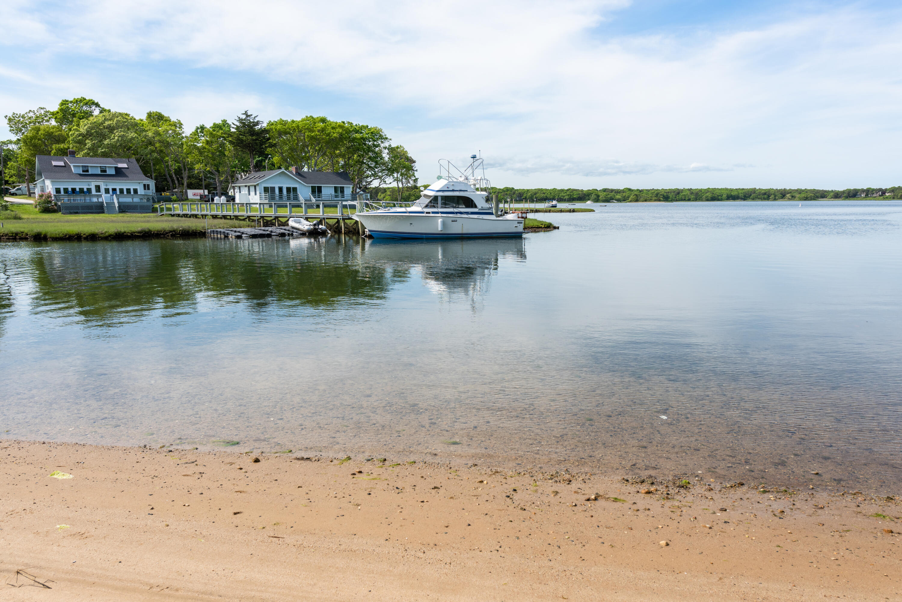 305 Monomoscoy Road Mashpee, MA 02649 - Photo 37 of 49 a view of a lake with a beach