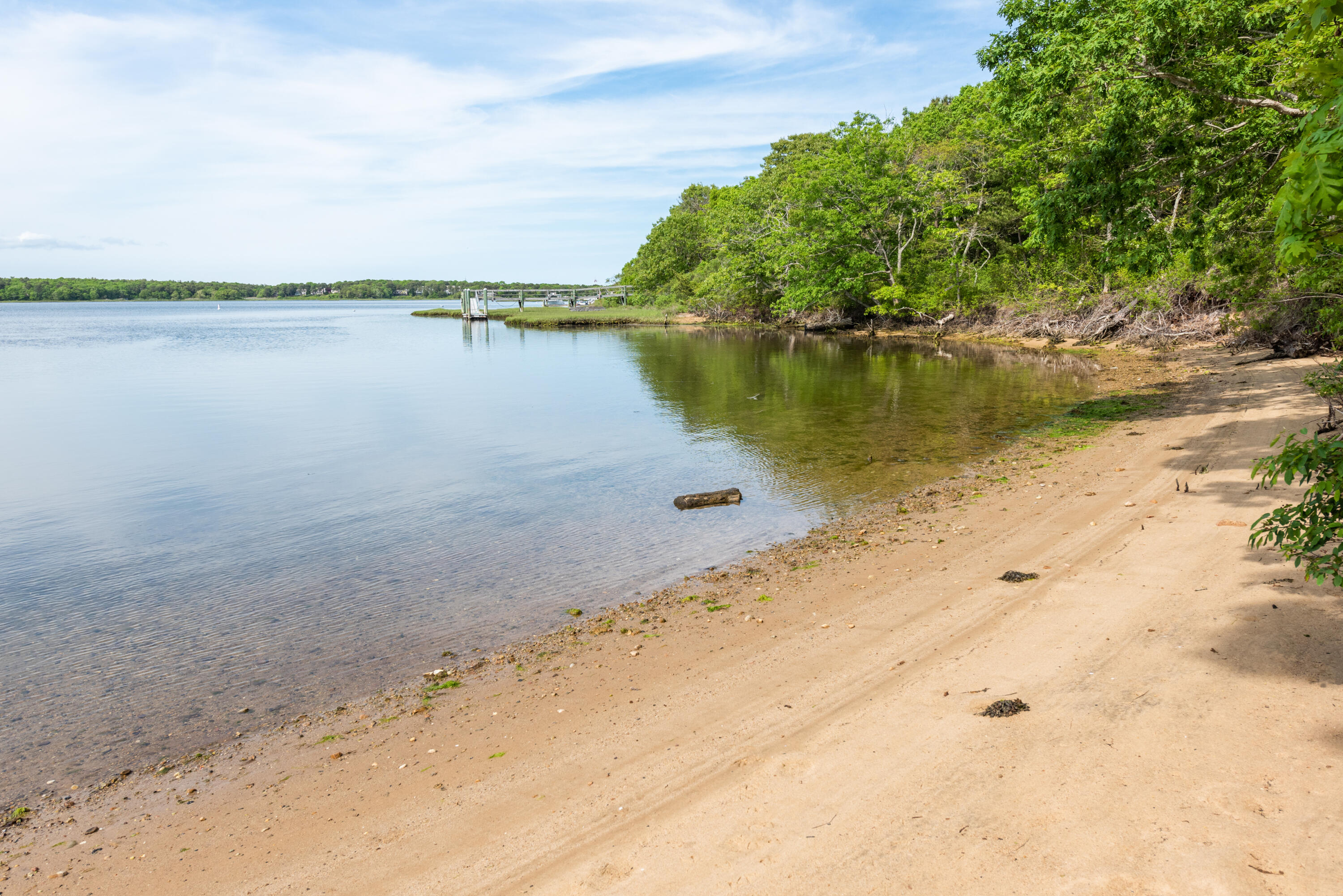 305 Monomoscoy Road Mashpee, MA 02649 - Photo 38 of 49 a view of a lake with beach in background