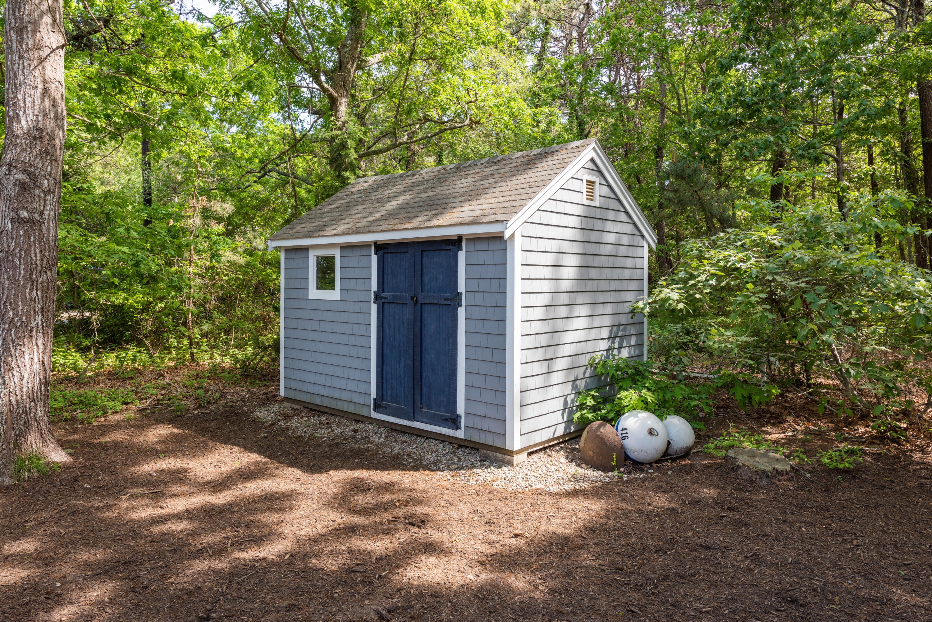 305 Monomoscoy Road Mashpee, MA 02649 - Photo 9 of 49 a view of a small house with a yard and large tree