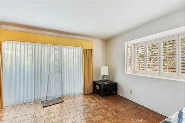 a view of an empty room with a fireplace and a window