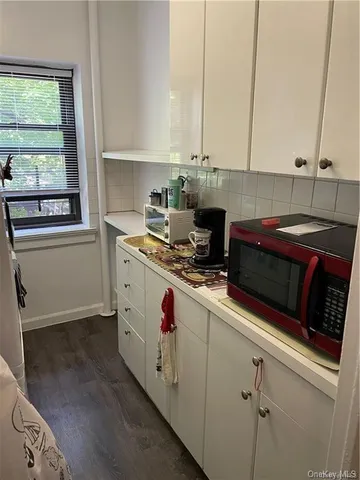 a kitchen with a sink and a stove next to a window