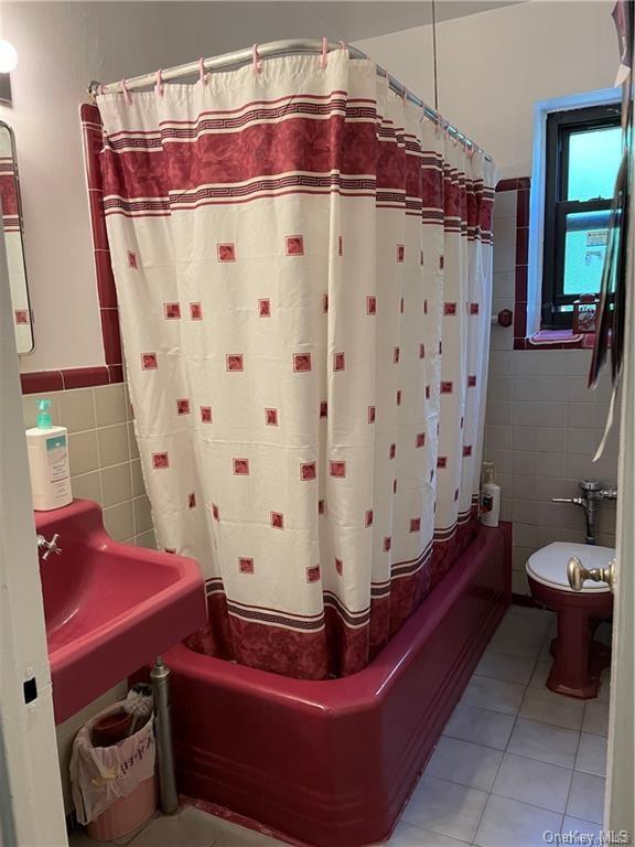 470 Broadway, Unit B2 Yonkers, NY 10705 - Photo 6 of 10 a bathroom with a sink a toilet and shower curtain