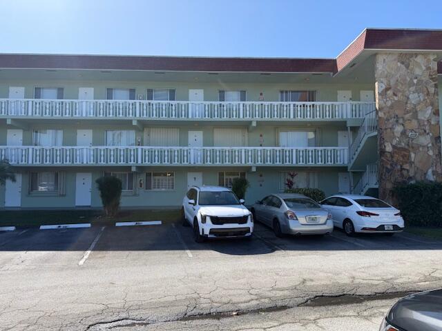3300 Springdale Boulevard, Unit 117 Palm Springs, FL 33461 - Photo 1 of 1 a couple of cars parked in front of a building