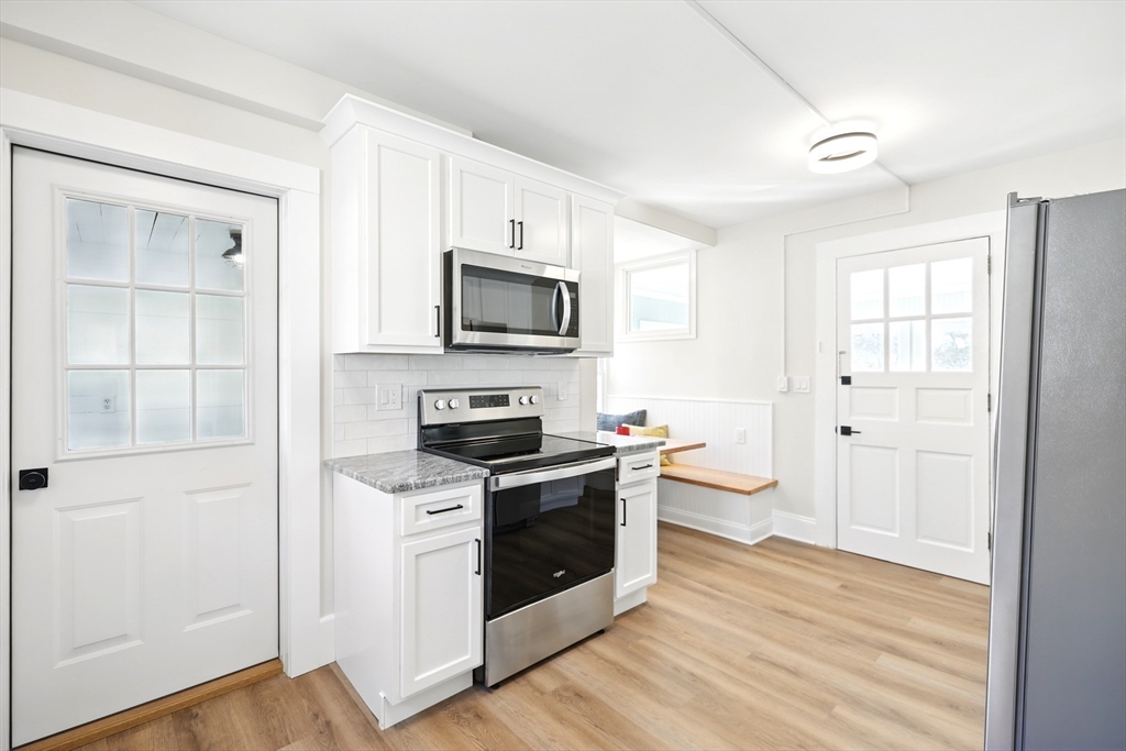 180 State Street, Unit A Northampton, MA 01060 - Photo 11 of 40 a kitchen with a stove a sink and a microwave