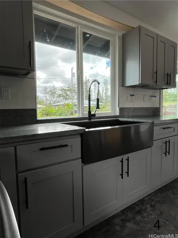 a kitchen with a sink and a large window