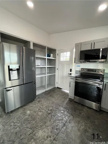 a kitchen with a refrigerator stove and microwave