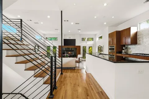 a kitchen with stainless steel appliances granite countertop a refrigerator a sink and a stove