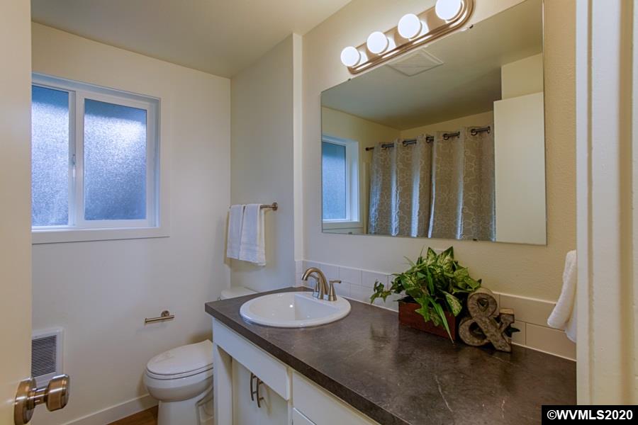 3245 Mistletoe Road Dallas, OR 97338 - Photo 18 of 28 a bathroom with a granite countertop sink a toilet and a mirror