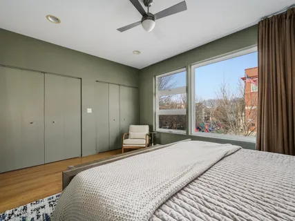 a bedroom with a large bed and a large window