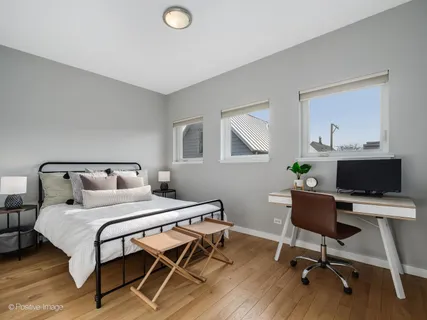 a bedroom with a bed a desk and chair