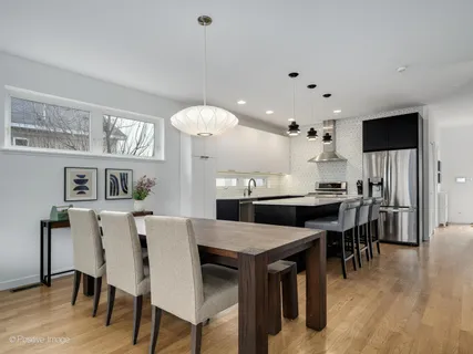 a large kitchen with a table and chairs