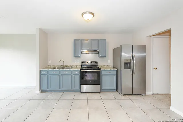 a kitchen with cabinets and stainless steel appliances