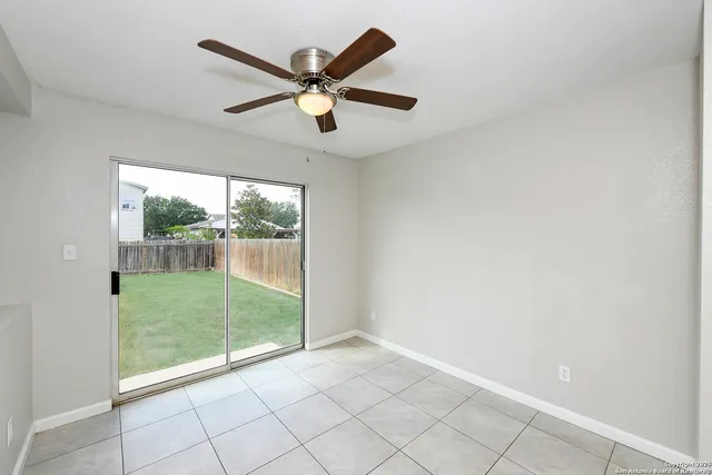 a view of a big room with wooden floor and windows