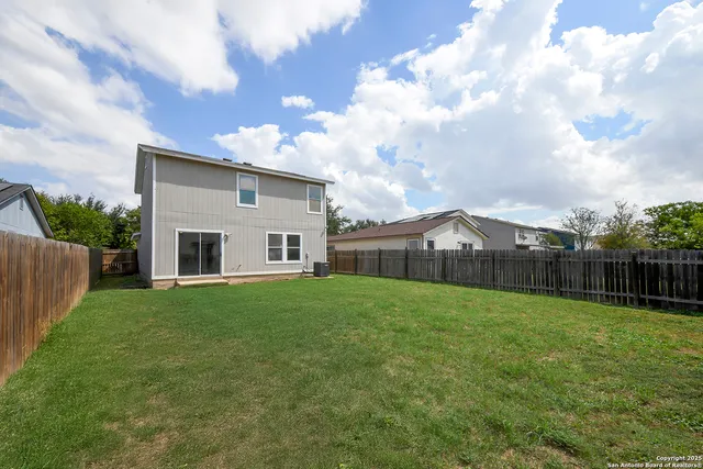 a view of a backyard of the house