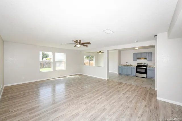 wooden floor in an empty room with a window