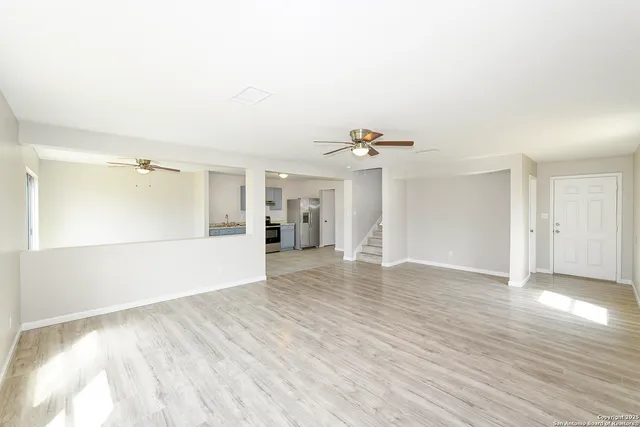 a view of an empty room with wooden floor