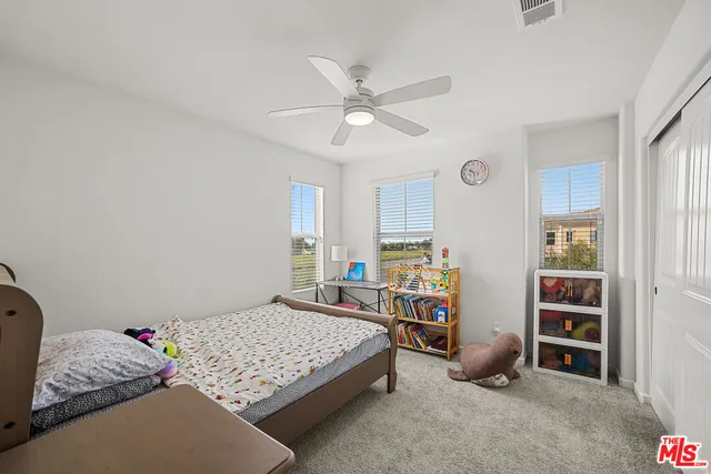 a bedroom with bed and a window