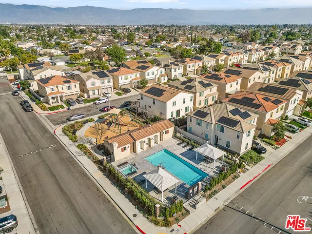 an aerial view of a residential apartment building with a city view