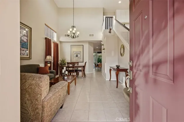 a living room with furniture and a chandelier