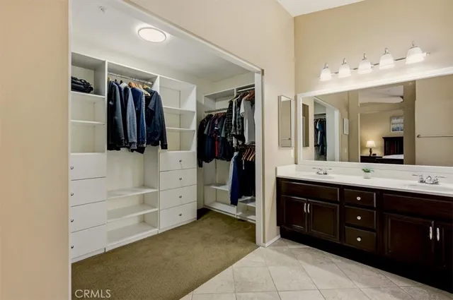 a spacious bathroom with a double vanity sink mirror and shower
