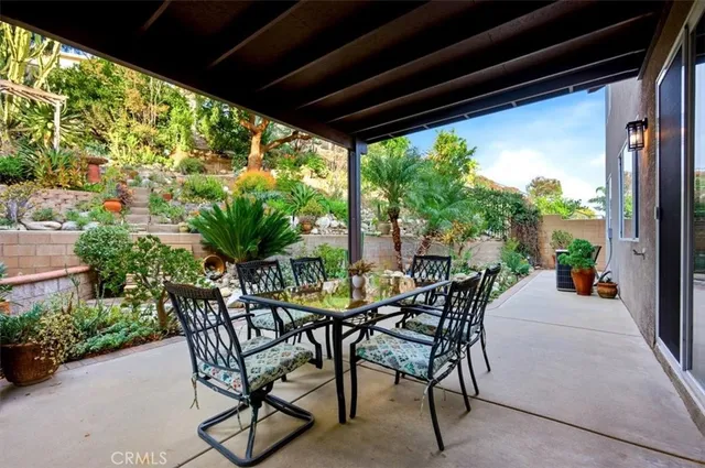 a view of a garden with flowers and trees