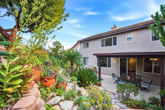 a front view of house with yard and outdoor seating