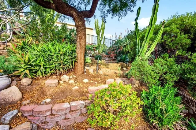 a front view of a house with a yard and potted plants
