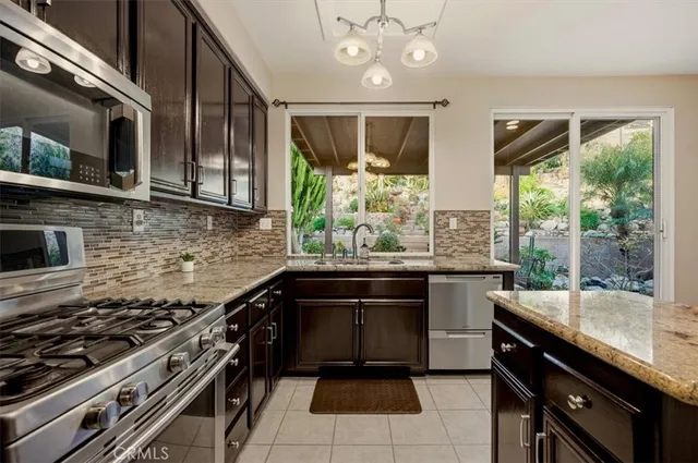 a kitchen with a stove sink and microwave