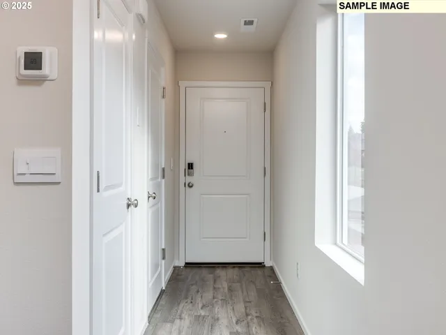 a view of a hallway with wooden floor