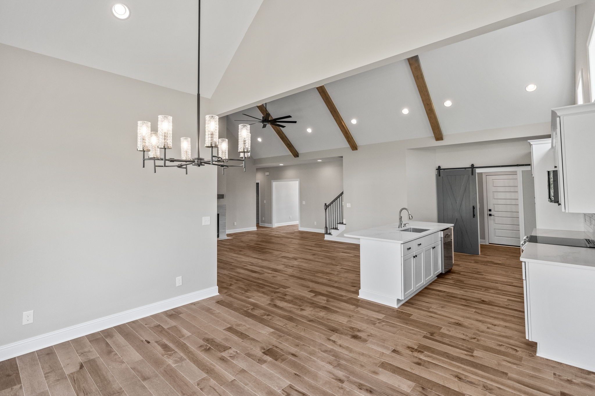 136 Augusta Trail Springfield, TN 37172 - Photo 27 of 31 a large kitchen with stainless steel appliances a large counter top a wooden floor and a ceiling fan