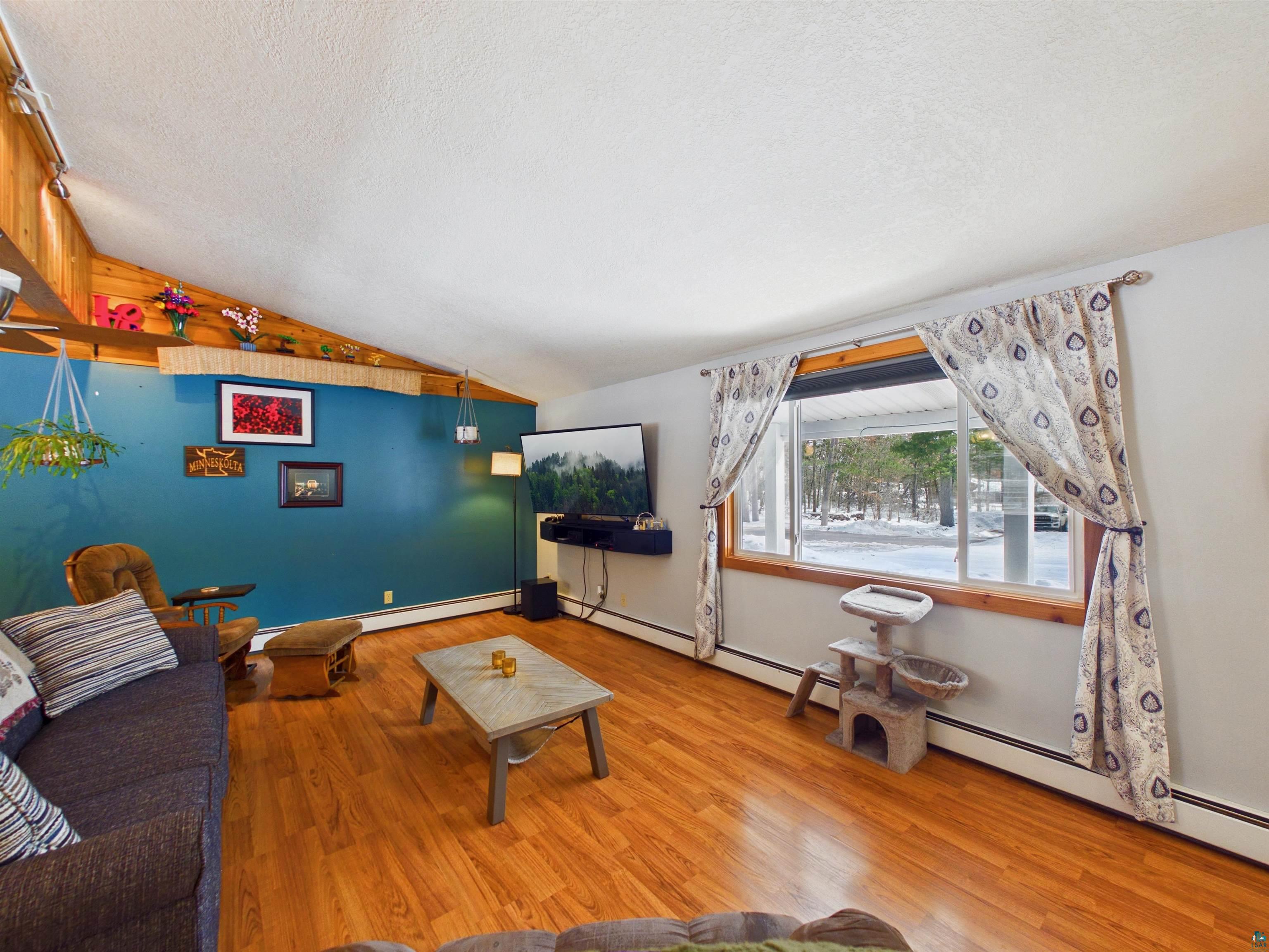 10719 North Oak Ridge Street Hayward, WI 54843 - Photo 11 of 57 Living area with a baseboard radiator and wood finished floors