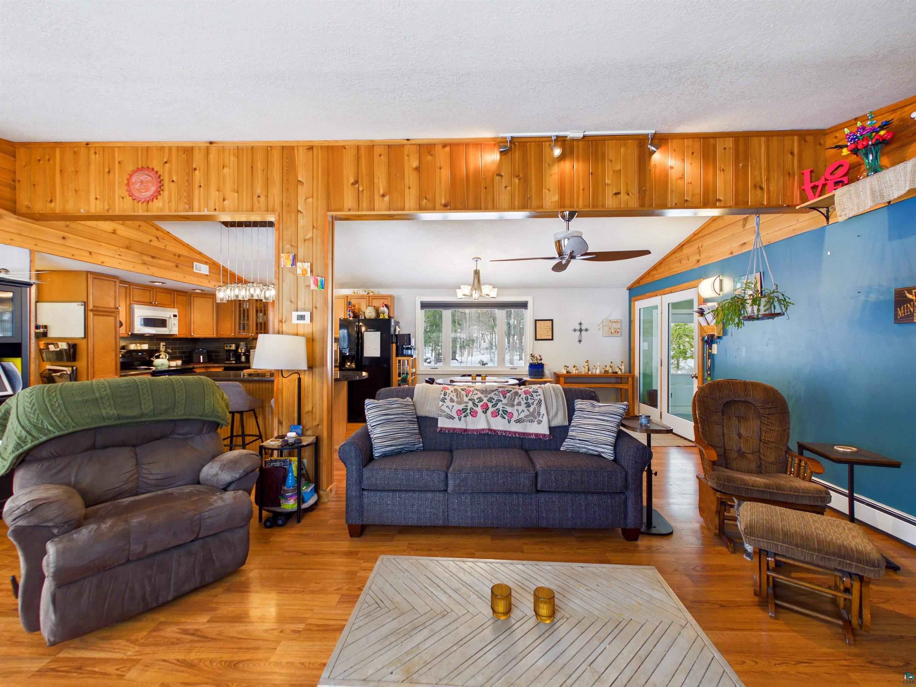 10719 North Oak Ridge Street Hayward, WI 54843 - Photo 13 of 57 Living area with light wood finished floors, ceiling fan, and hanging lights