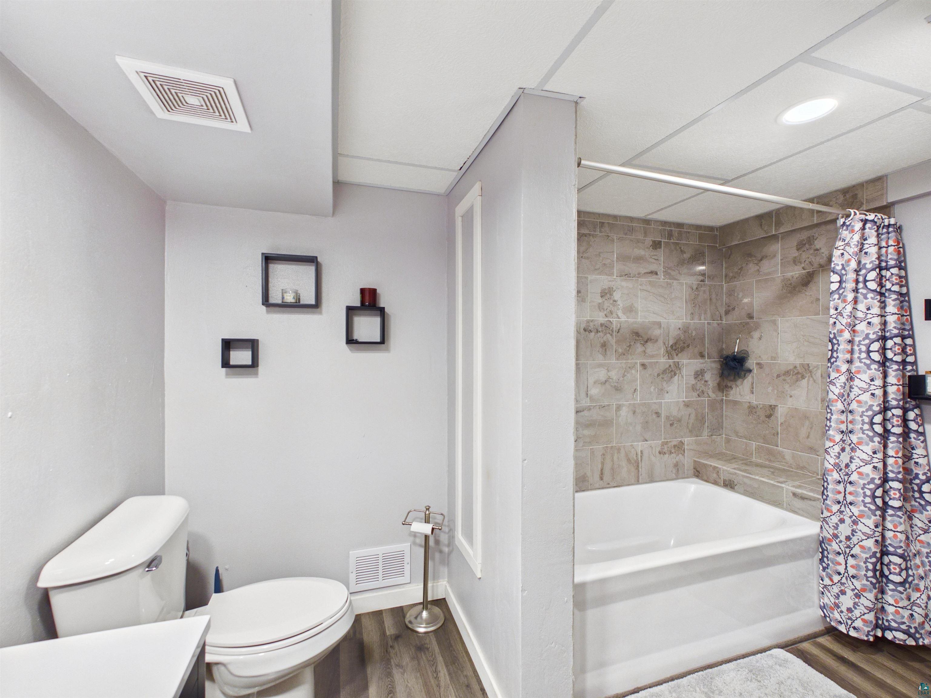 10719 North Oak Ridge Street Hayward, WI 54843 - Photo 43 of 57 Full bathroom featuring dark wood-type flooring, shower / bath combo, and vanity