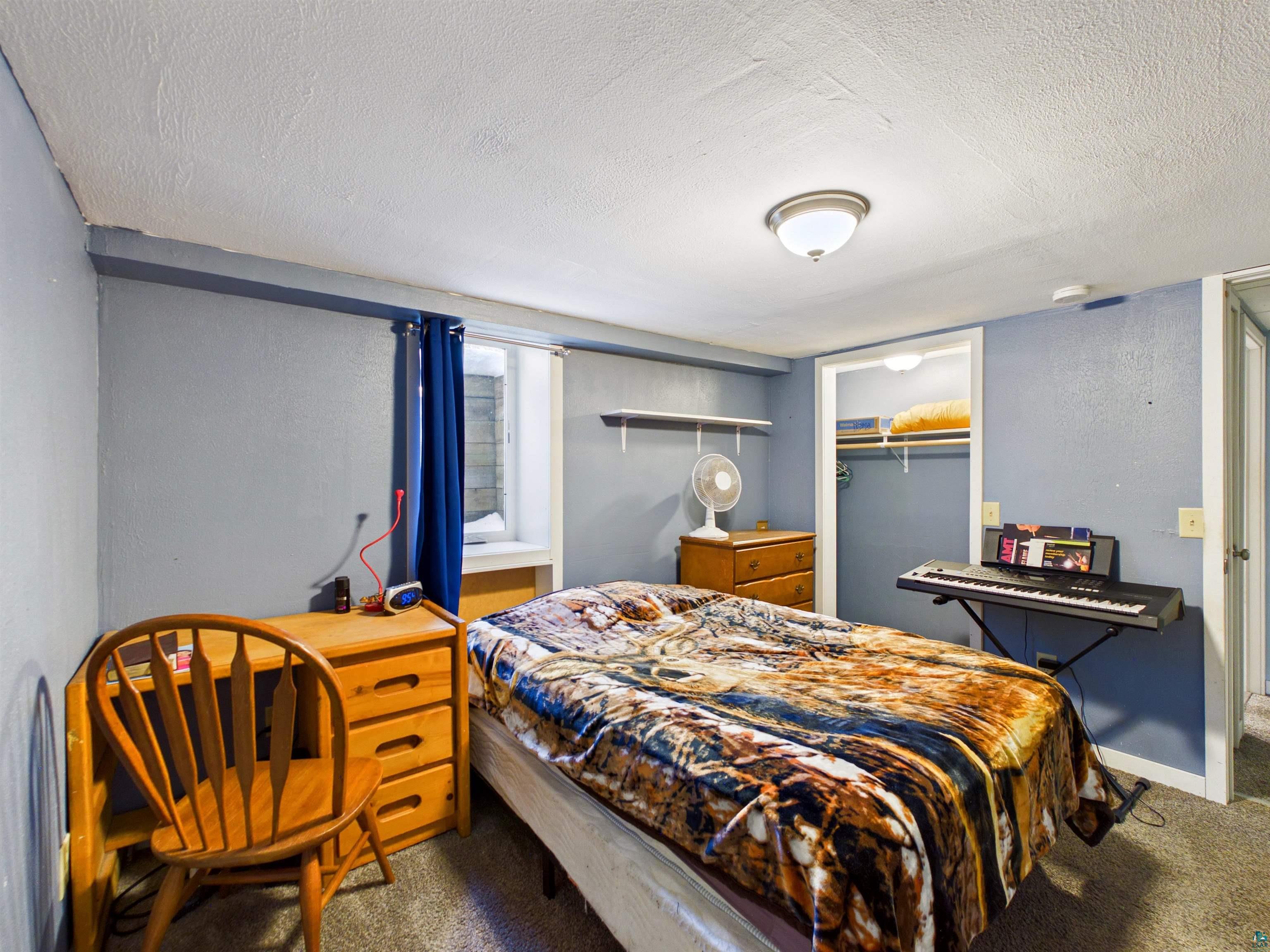 10719 North Oak Ridge Street Hayward, WI 54843 - Photo 46 of 57 Carpeted bedroom with a closet and a textured ceiling