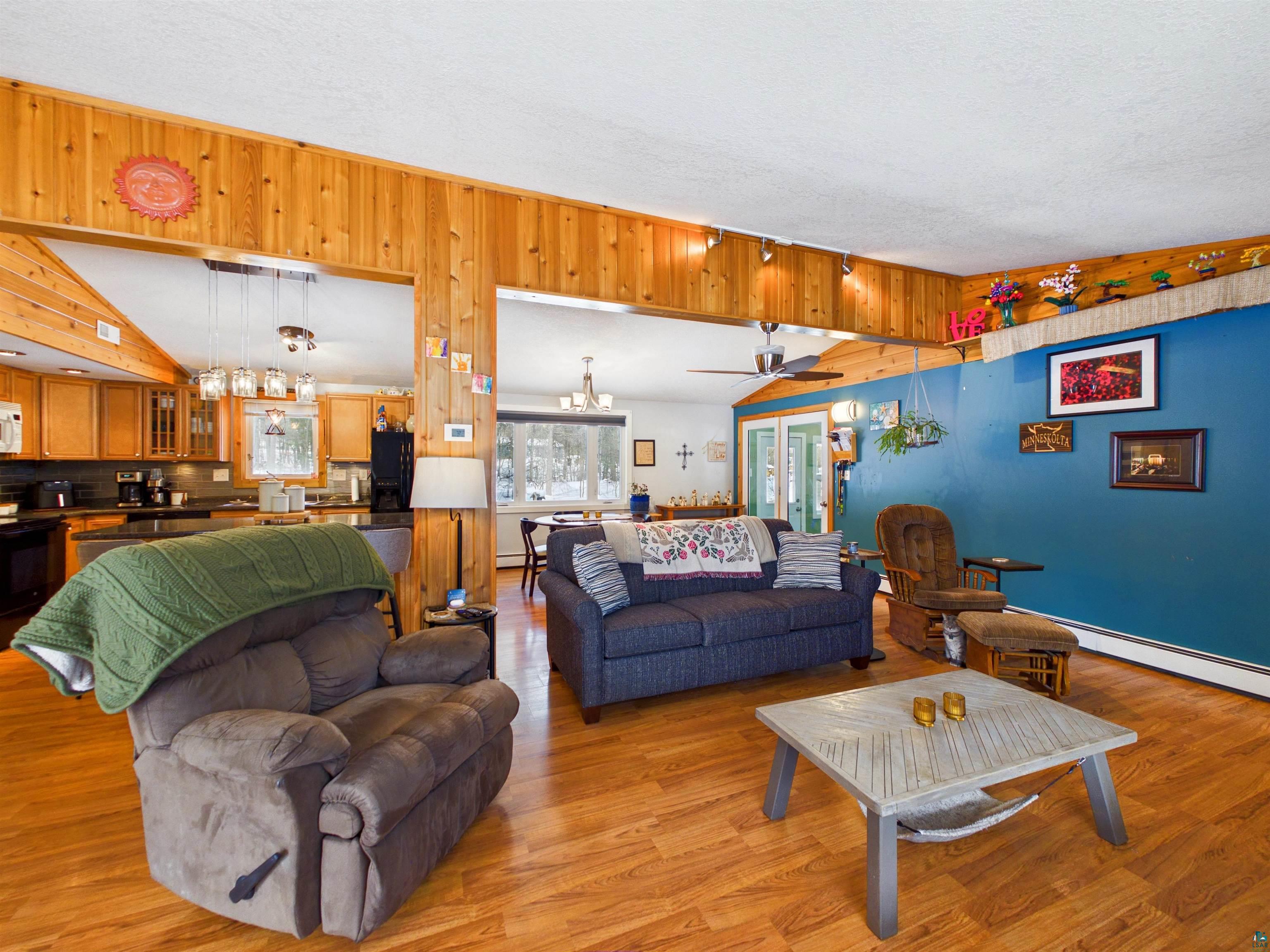 10719 North Oak Ridge Street Hayward, WI 54843 - Photo 10 of 57 Living room featuring a ceiling fan, light wood finished floors, and hanging lights