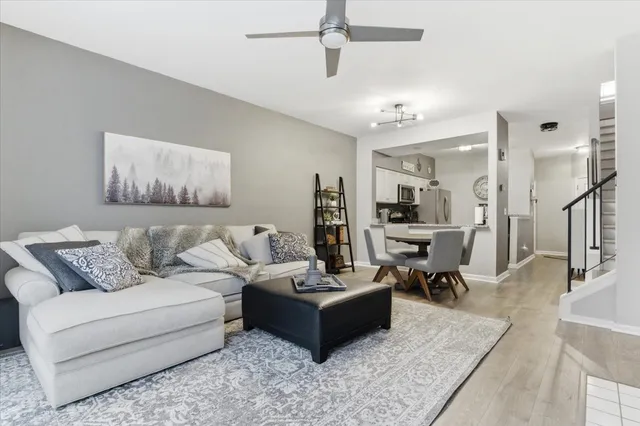 a living room with furniture and view of kitchen