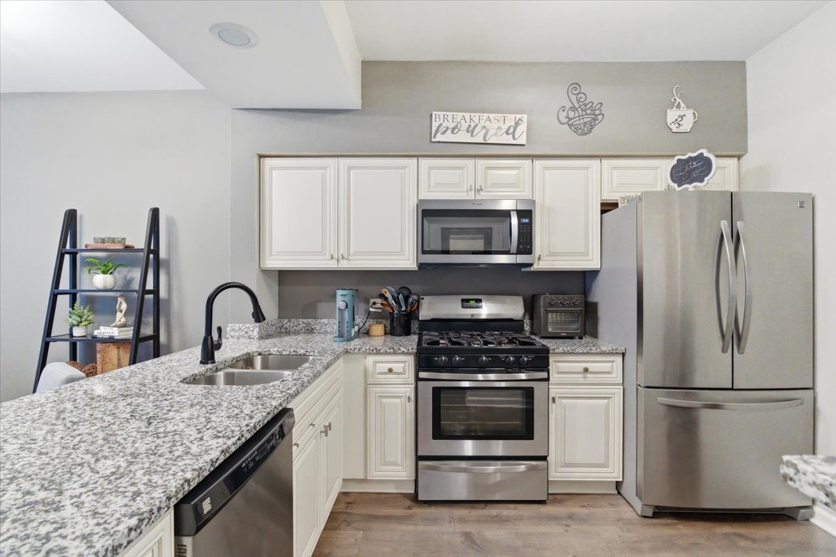1389 South Candlestick Way Waukegan, IL 60085 - Photo 6 of 12 a kitchen with appliances a sink cabinets and a counter top space