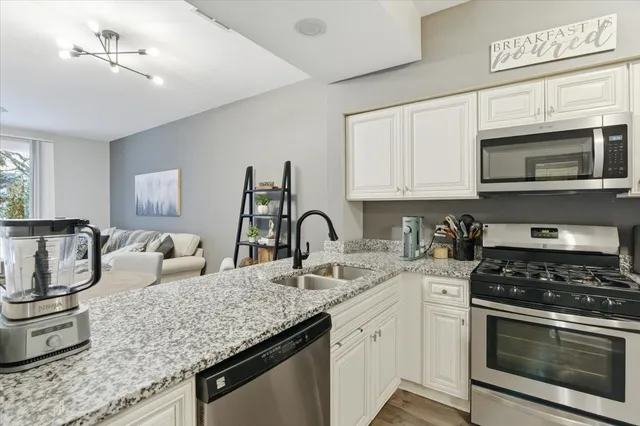 a kitchen with granite countertop a stove and a sink