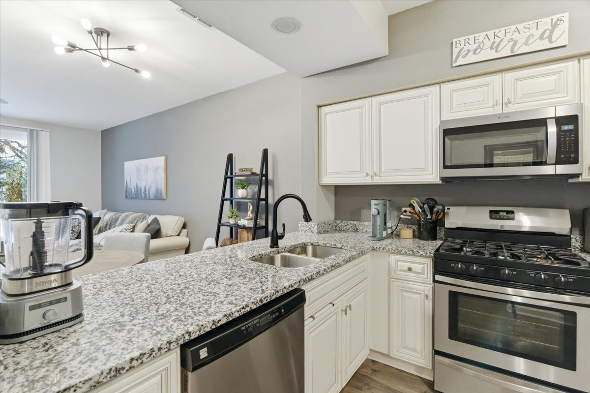 1389 South Candlestick Way Waukegan, IL 60085 - Photo 7 of 12 a kitchen with granite countertop a stove and a sink