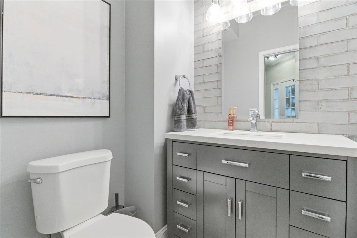 1389 South Candlestick Way Waukegan, IL 60085 - Photo 9 of 12 a bathroom with a toilet a sink and mirror