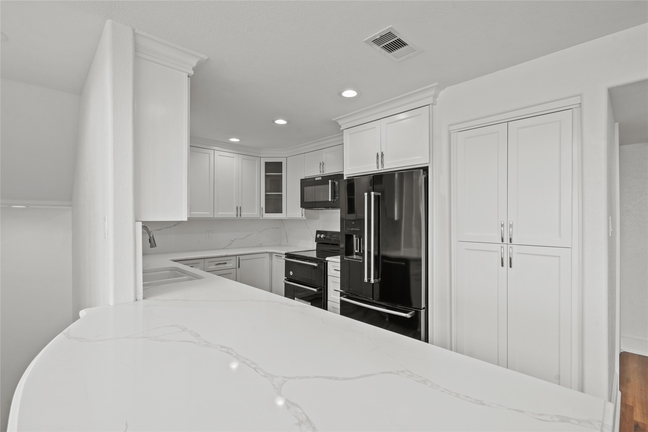407 Isles End Road Tiki Island, TX 77554 - Photo 11 of 34 a kitchen with stainless steel appliances a refrigerator and a stove top oven