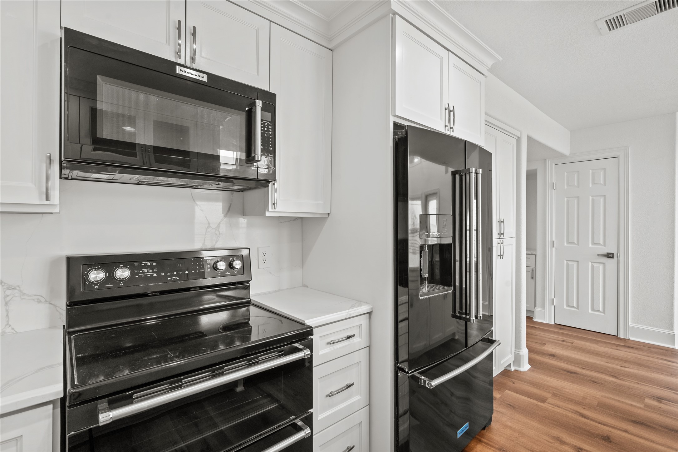407 Isles End Road Tiki Island, TX 77554 - Photo 13 of 34 a kitchen with wooden cabinets and stainless steel appliances